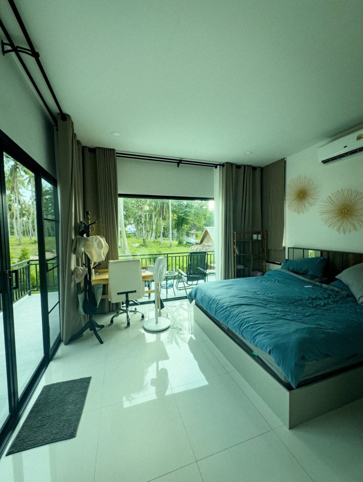 Airbnb bedroom with balcony before and after AI photo enhancement: brighter, balanced and true to the real room - before