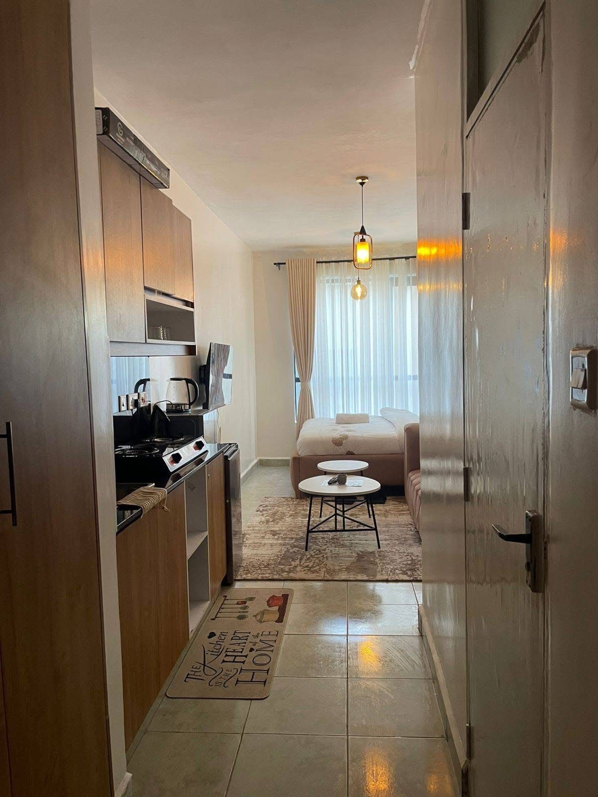 Studio kitchenette and entrance shot on a phone, before and after ProLister enhancement - before